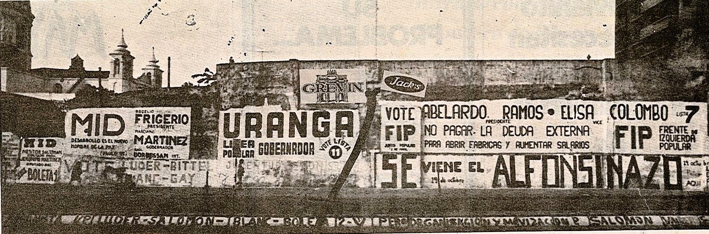 En 1983, un paredón -hoy inexistente- ubicado sobre calle 25 de Mayo, cubierto en plena campaña con las tradicionales pintadas de los candidatos de la época.